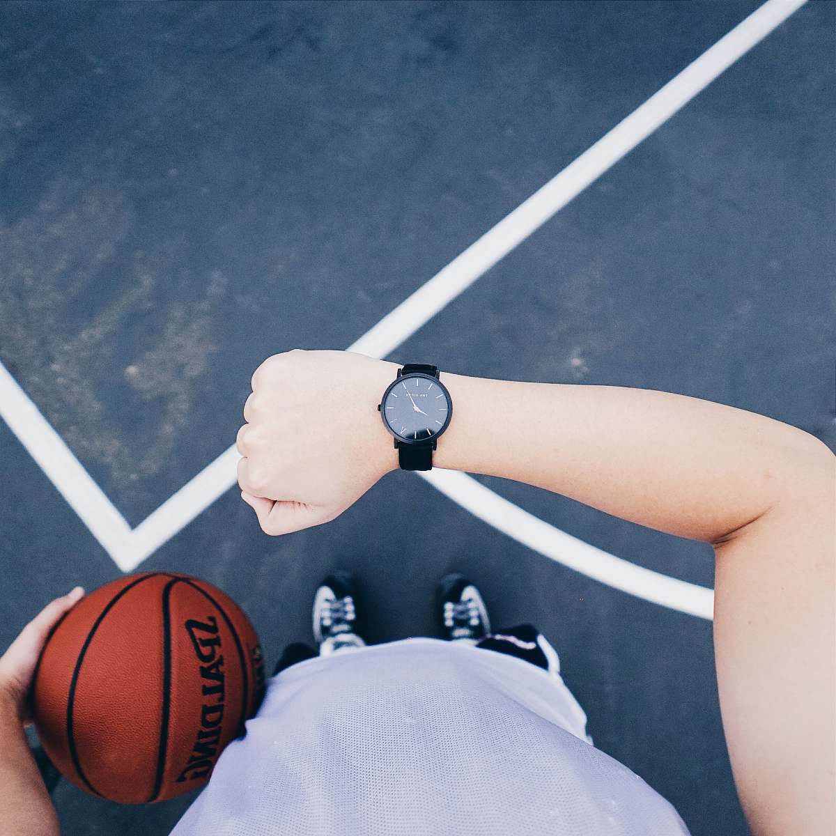 united states person wearing black analog watch basketball